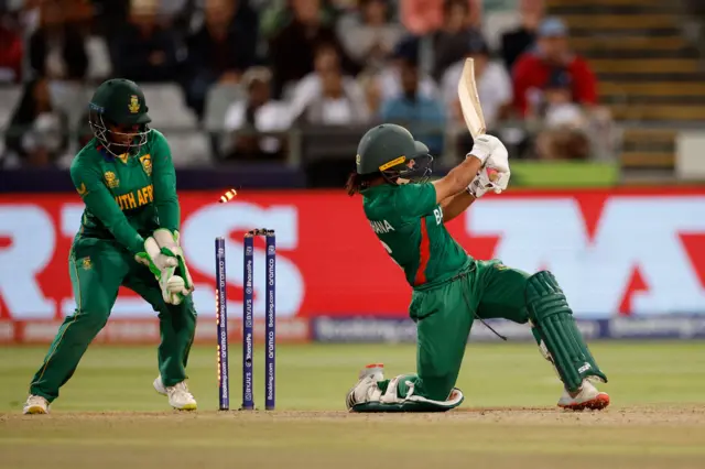 Bangladesh's Sobhana Mostary (R) is bowled by South Africa's Nonkululeko Mlaba (not seen) during the Group A T20 women's World Cup cricket match between South Africa and Bangladesh at Newlands Stadium in Cape Town