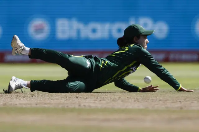 Pakistan's Tuba Hassan stretches to field the ball during the Group B T20 women's World Cup cricket match between England and Pakistan at Newlands Stadium in Cape Town