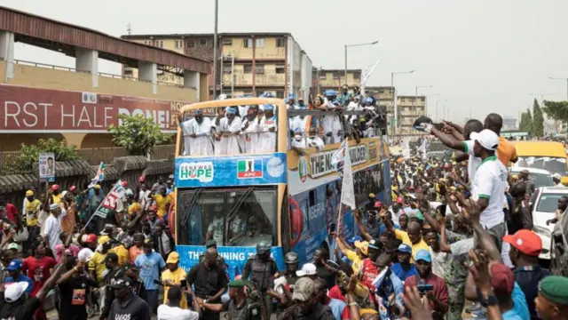 Nigerian presidential candidate Bola Tinubu arrives by bus at Teslim Balogun Stadium in Lagos on 21 February 2023