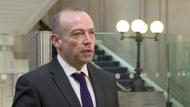 Northern Ireland Secretary of State Chris Heaton-Harris talks to the media