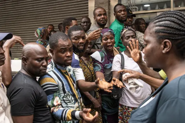 Angry people outside bank