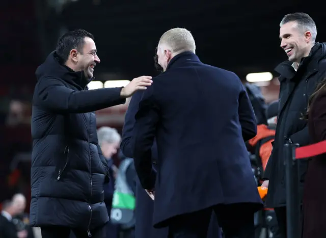 Xavi speaks to Paul Scholes and Robin Van Persie pre match.