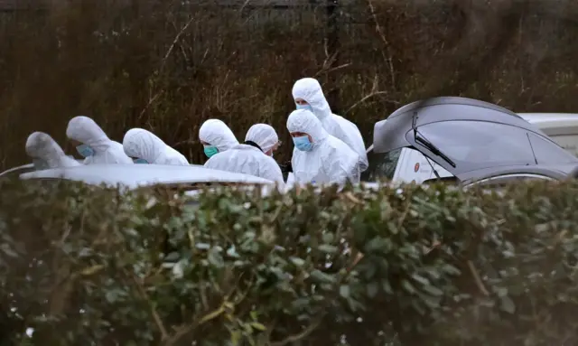 Forensic officers at the scene of John Caldwell's shooting