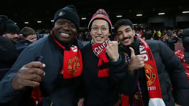 Manchester United fans smile on as they go into the last 8 of the Europa League.