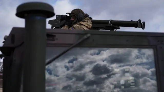 Ukrainian soldier uses a stinger - a portable system firing a surface-to-air missile - mounted on a military Hummer vehicle