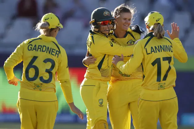 Australia's Jess Jonassen (2nd R) celebrates with teammates after the dismissal of India's Sneh Rana (not seen) during the semi-final T20 women's World Cup cricket match between Australia and India at Newlands Stadium