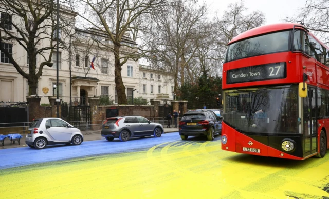 Protesters pour paint outside Russian embassy in west London