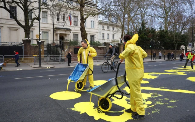 Protesters pour paint outside Russian embassy in west London