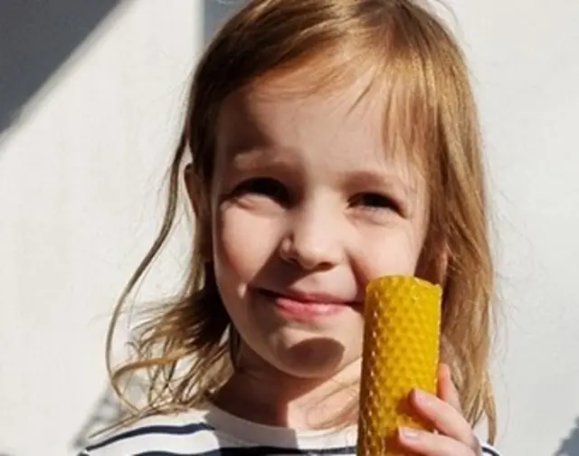 Marta holding a candle she made at school