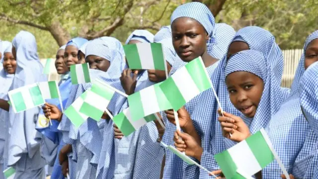 Students old Nigerian national flags