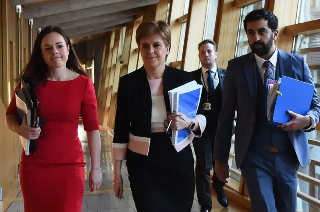 Nicola Sturgeon flanked by Kate Forbes (left) and Humza Yousaf (right) in February 2020