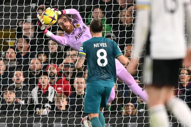 Wolves goalkeeper Jose Sa makes a save from a header made by Fulham striker Carlos Vinicius