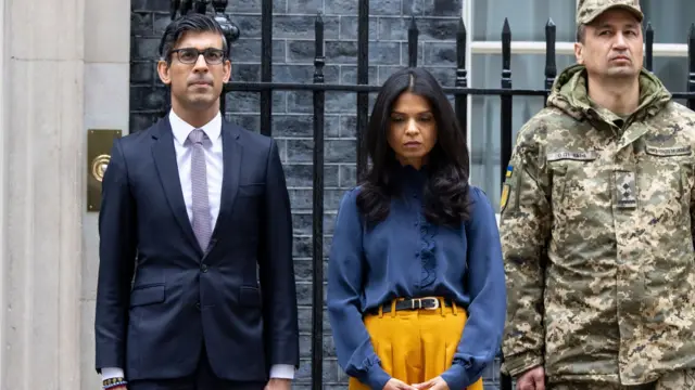 UK PM Rishi Sunak and his wife, Akshata Murthy, during a minute's silence outside 10 Downing Street