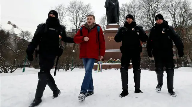 Police officers detain a man who laid flowers at the monument of Ukrainian poet and writer Taras Shevchenko in St. Petersburg