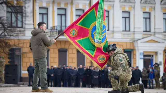 Ukrainian President Volodymyr Zelensky honours troops at a ceremony to mark the war's year anniversary