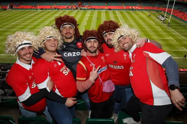 Fans in wigs in stadium