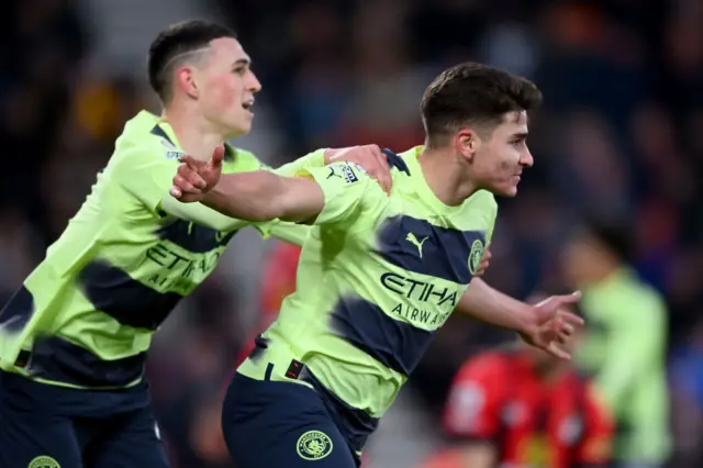 Manchester City's Julian Alvarez celebrates scoring with Phil Foden