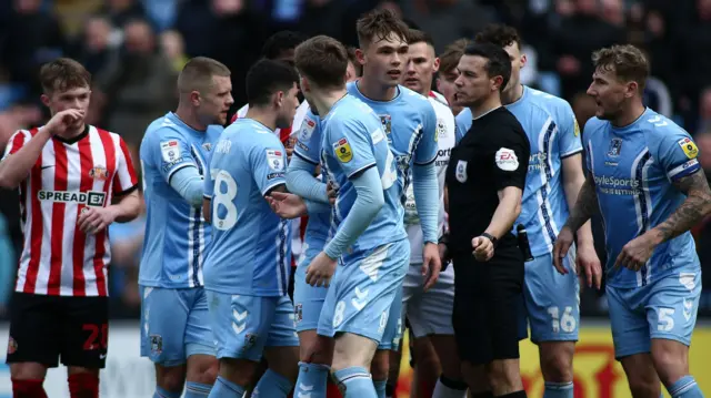 Players surround referee