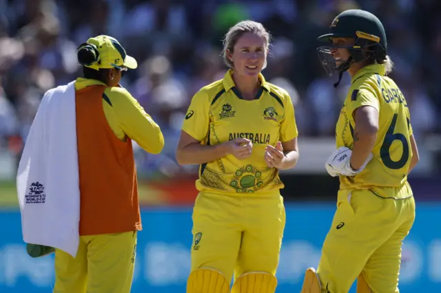 Australia's Ashleigh Gardner (R), Australia's Beth Mooney (C) and Australia's Alana King (L) talk between overs during the final T20 women's World Cup cricket match between South Africa and Australia at Newlands Stadium in Cape Town