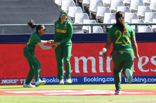 South Africa's Shabnim Ismail (L), South Africa's Sune Luus (C) and South Africa's Chloe Tryon (R) celebrate after the dismissal of Australia's Ashleigh Gardner (not seen) during the final T20 women's World Cup cricket match between South Africa and Australia