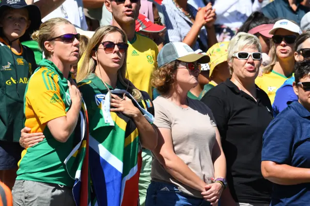 South African fans sing their national anthem during the final T20 women's World Cup cricket match between South Africa and Australia at Newlands Stadium in Cape Town