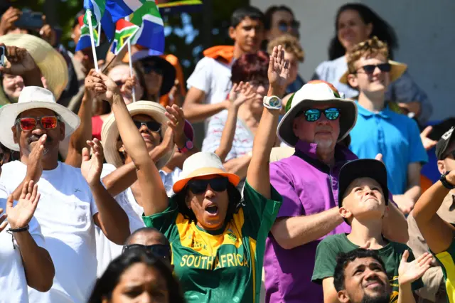 South African supporters cheer during the final T20 women's World Cup cricket match between South Africa and Australia at Newlands Stadium in Cape Town