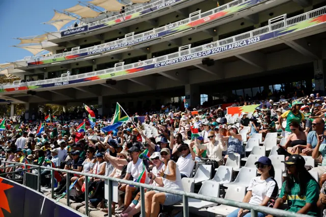 Supporters wave South African flags ahead of the final T20 women's World Cup cricket match between South Africa and Australia at Newlands Stadium in Cape Town