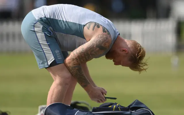 Ben Stokes checking his phone during England training