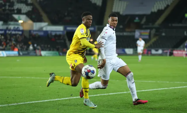 Swansea's Morgan Whitaker and Rotherham's scorer Chiedoze Ogbene battle for the ball.