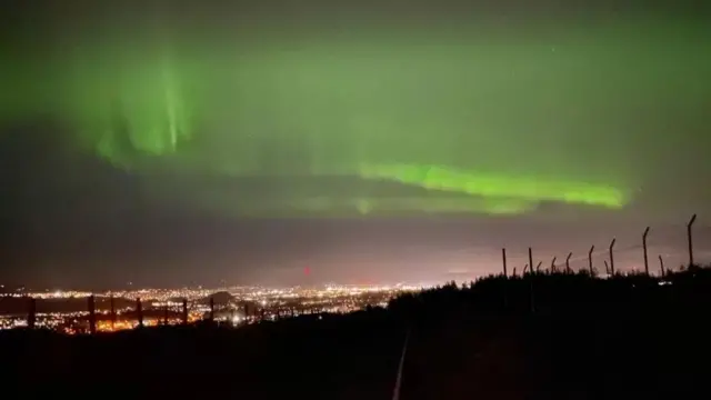 Reporter Steven McKenzie and his daughter Ella raced to the top of a local hill above Inverness to get the best view