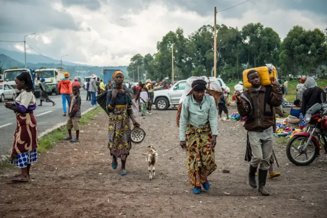 Internally displace people from the Kibumba area near the North Kivu city of Goma, arrive on May 25, 2022 at the Kunyaruchinya school trying to shelter from the ongoing clashes between the Congolese Army and the M23 rebels