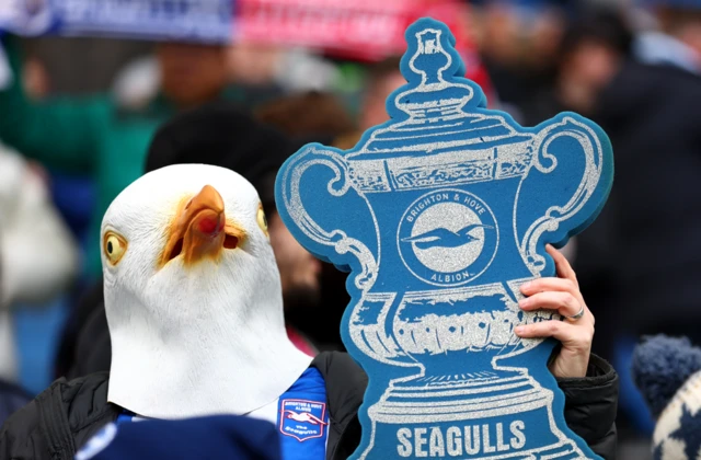 Brighton fans with a silver FA Cup