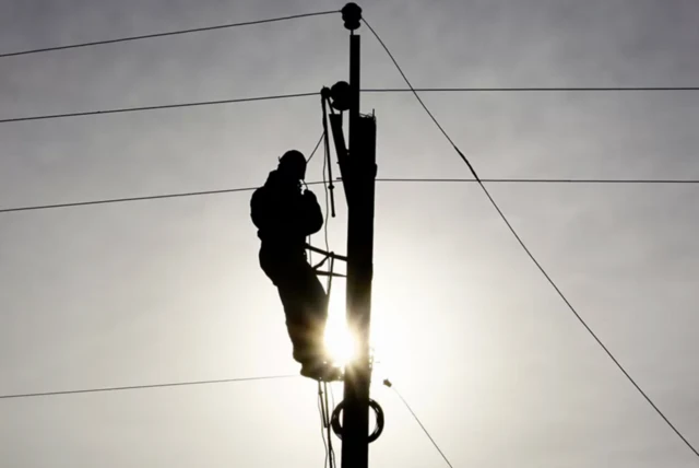 Man fixing power lines