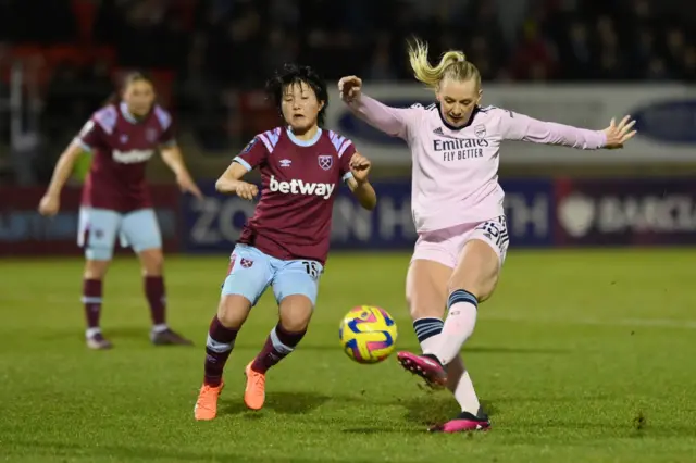 Stina Blackstenius shoots over the bar under pressure from Honoka Hayashi.