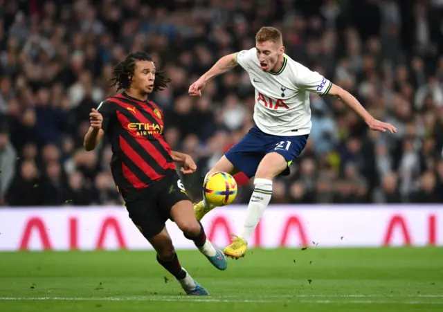 Nathan Ake challenges Dejan Kulusevski