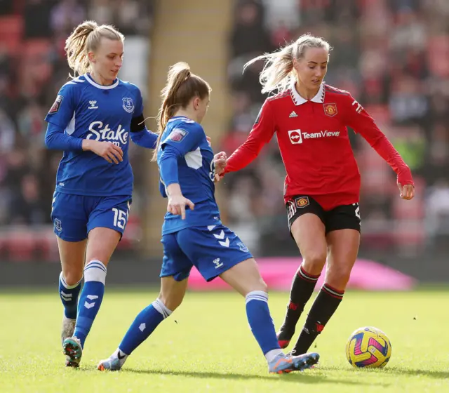 Millie Turner dribbles away from Maya Le Tissier and Martha Thomas