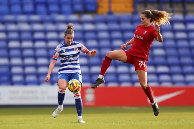 Deanna Cooper clears the ball under pressure from Katie Stengel