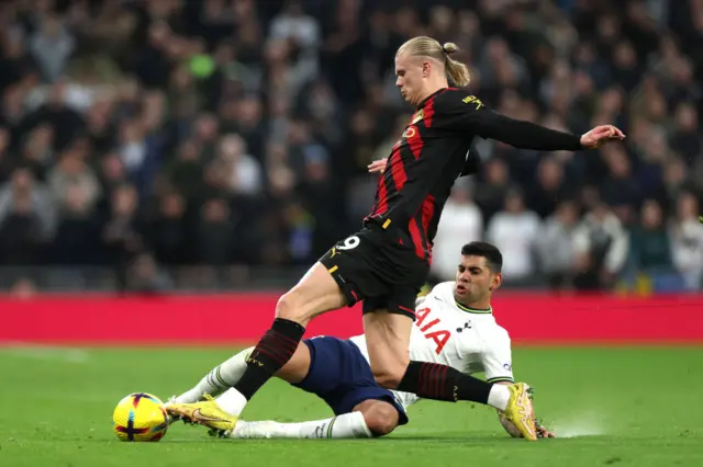 Erling Haaland is fouled by Cristian Romero