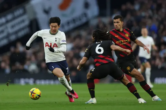 Son Heung-Min runs at Nathan Ake