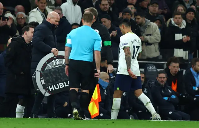 Cristian Romero walks down the tunnel