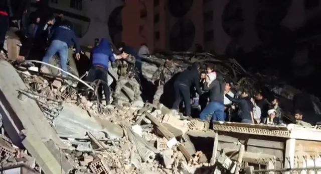 In this video grab from AFP TV taken on February 6, 2023, rescuers search for victims of a 7.8-magnitude earthquake that hit Diyarbakir, in southeastern Turkey, levelling buildings across several cities and causing damages in neighbouring Syria. (Photo by Mahmut BOZARSLAN / AFPTV / AFP) (Photo by MAHMUT BOZARSLAN/AFPTV/AFP via Getty Images)