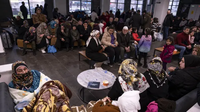 People sit in a local authority building in Diyarbakir