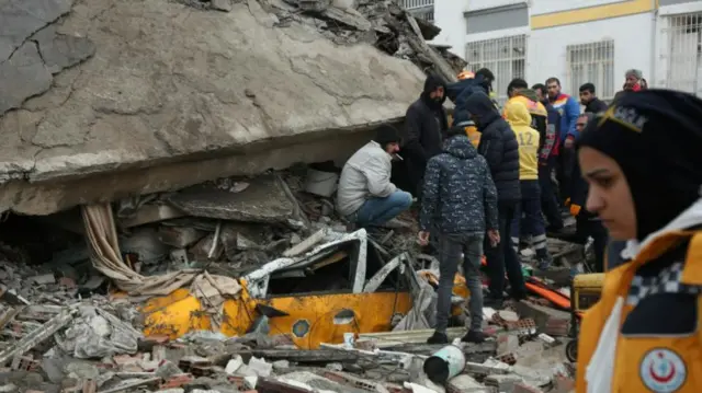 Rescuers search for survivors under the rubble following an earthquake in Diyarbakir