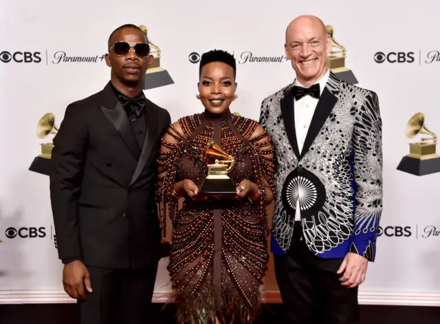 Zakes Bantwin, Nomcebo Zikode, and Wouter Kellerman pose in the press room during the 65th GRAMMY Awards