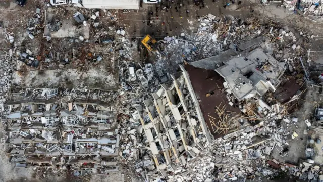 A photo taken with a drone shows a an aerial view over collapsed buildings after an earthquake in Hatay, Turkey