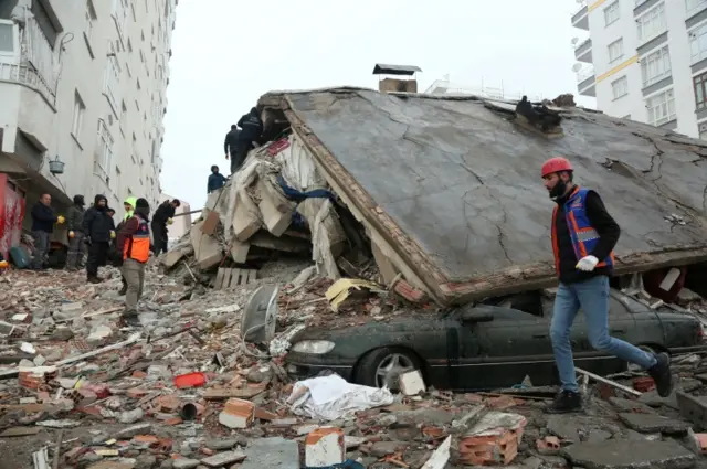 Rescuers search for survivors under the rubble following an earthquake in Diyarbakir, Turkey