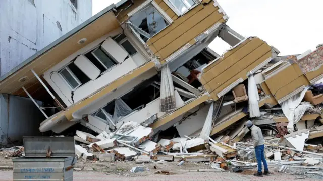 A view shows a collapsed building following an earthquake in Hatay province, Turkey