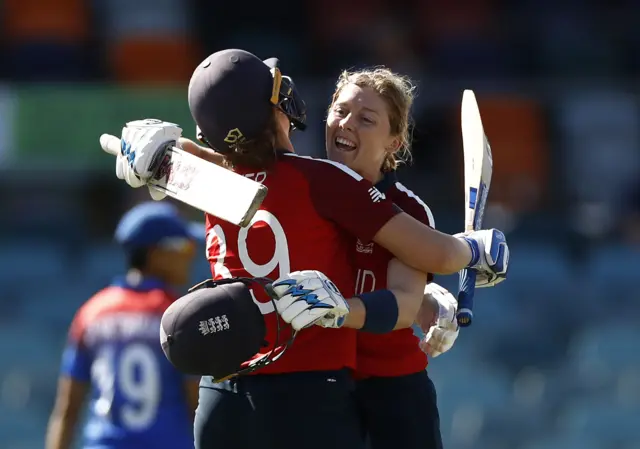 England's Heather Knight celebrates with Nat Sciver-Brunt after hitting a century against Thailand in the 2020 T20 World Cup to become the first women's cricketer to hit a century in all formats of the game