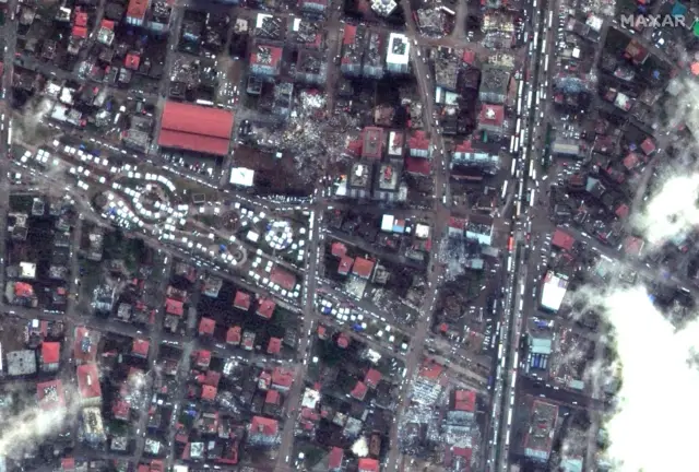 Collapsed building and rescue tents can be seen in the aftermath of the earthquake in Nurdagi, Turkey