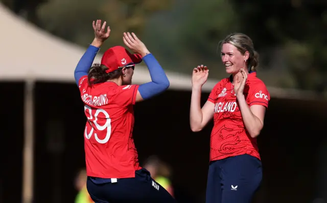 England's Lauren Bell celebrates taking a wicket with Nat Sciver-Brunt during a 2023 Women's World Cup game against South Africa